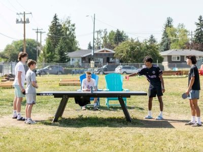 image of kids playing ping pong on outdoor table